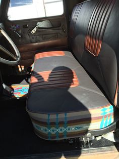 the interior of a vehicle with an upholstered seat and foot rest on it