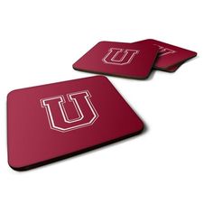 two red coasters with the letter u on them, one in white and one in maroon