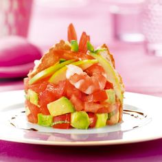 a plate topped with a sandwich covered in lots of veggies