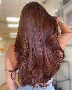 the back of a woman's head with long red hair