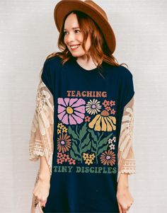 Teaching Tiny Disciples Tshirt/Momming is My Ministry/Motherhood is my Ministry/Homeschool Shirt/Christian Homeschool Mom Christian Mom Gift Crafted from lightweight cotton that is perfect for active wear or leisure, our Teaching Tiny Disciples t-shirt offers comfort and retro style. It's ideal for casual wear, whether going to work, grabbing coffee with friends, or just wanting to wear a comfortable shirt during daily activities. Whether you're curled up on the couch, hanging out with your fami School Spirit Graphic Print Tops For Spring, Spring Graphic Print Top For School Spirit, Homeschool Mom Shirts, Relaxed Fit Tops For School In Spring, Blue Spring Tops With School Spirit Style, Blue Tops For Spring School Spirit, Blue Spring Tops For School Spirit, Blue Relaxed Fit Tops For School, School Spirit Letter Print Top