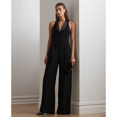 With a nod to traditional tuxedo designs this jumpsuit features a vest-inspired bodice with a satin shawl collar and a wide-leg silhouette accented by satin side-stripes and creases along each leg. A refined choice for a special occasion this style is crafted with double-faced crepe for a smooth hand feel. Sleeveless Satin Jumpsuits For Evening, Elegant Wide Leg Semi-formal Suits, Elegant Satin Pantsuit For Evening, Elegant Wide Leg Suits For Semi-formal Occasions, Chic Silk Party Suits, Elegant Evening Silk Suits, Elegant Satin Jumpsuits And Rompers For Workwear, Fitted Satin Pantsuit For Workwear, Elegant Sleeveless Jumpsuits And Rompers For Night Out