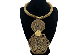 Add an authentic and unique touch to your jewellery collection with this pendant Necklace. The necklace features beautiful gold beads and a brass pendant that is intricately beaded, making it a perfect accessory for any outfit. The pendant is a traditional ethnic design that showcases the unique and diverse African culture. This necklace is ideal for anyone who loves adding elegance and uniqueness to their style. The necklace is handmade with attention to detail, ensuring that every piece is of high quality. Show off your love for African culture while adding a pop of colour to your outfit with this beautiful necklace. Material: Beads, Brass Colour: Gold Length of pendant - 6.5 inches/16.5cms Neck width - 18 inches/46cms. Gold Metal Necklace With Polished Beads, Gold Necklaces With Metal Beads, Gold Necklace With Polished Metal Beads, Gold Beaded Metal Necklace, Gold Metal Beads With Beaded Chain, Gold Beaded Chain Metal Necklaces, Gold Beaded Metal Necklaces, Gold Metal Beaded Chain Necklace, Adjustable Brass Necklaces With Gold Beads