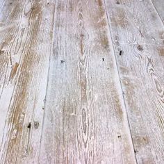 an old wooden table with white paint and wood grains on it's surface