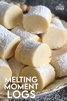 the cover of melting moment logs is shown with powdered sugar cubes on top