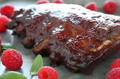 meatloaf with raspberries on the side and green leafy garnish