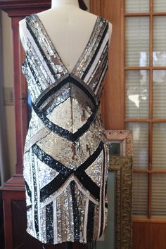 Black white silver striking beaded pattern on this fabulous flapper dress! This is a stunner! More pics: https://www.facebook.com/pg/RetroVintageWeddings1920s1930s/photos/?tab=album&album_id=2682689598493733 Gatsby Wedding Dress, 1930s Style, Deco Dress, Art Deco Dress, Dress Sequin, Wedding Dresses Beaded, Beaded Wedding, 1930s Fashion, Tres Chic