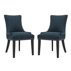 a pair of blue upholstered chairs with studded trimmings on the legs