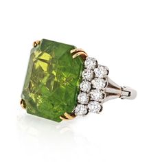 The August birthstone, peridot, symbolizes strength. ... It was once believed that the green peridot crystals found in volcanic ashes were the tears of the volcano goddess, Pele. When set in gold, this gem was said to protect the wearer from nightmares. Bright green emerald cut peridot cocktail ring with brilliant cut Goddess Pele, Volcano Goddess, Emerald Cut Diamond Ring, Peridot Crystal, Ring Shank, Wide Ring, August Birthstone, Green Peridot, August Birth Stone