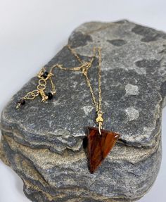 "PETRIFIED WOOD PENDANT WITH DAINTY GOLD FILLED CHAIN NECKLACE Details: Handmade item Necklace length: 14\" Extender: 2\" Pendant height: 3/4\" Materials: Gold Filled  Stone: Petrified Wood This necklace features a hand crafted piece of petrified wood on a gold filled chain. The necklace is 14\" long. The necklace in the pictures is the exact one for sale.  Caring for Gold Filled items is as easy as caring for any gold jewelry. Simply keep away from chemicals, clean regularly with mildly sudsy water, rinse well and pat dry with a non-scratching cloth. Polish gently with a jewelry polishing cloth. To do this, use a microfiber cloth or special jewelry cloth (not paper towels or toilet paper) to clean your piece." Australian Opal Pendant, Wood Necklace, Paper Towels, Wood Pendant, Special Jewelry, Petrified Wood, Opal Pendants, Polish Jewelry, Gold Filled Chain