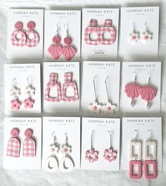 six pairs of pink and white earrings on display