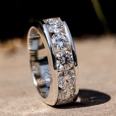 a wedding ring with five diamonds on it