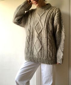 Handmade vintage beige / gray chunky fisherman sweater, 100% virgin wool, made in Portugal. It has an oversized fit, and is really warm.  Its natural material, and geometric knit makes it atemporal, and it will be a staple in your wardrobe forever. Plus it is really cozy and warm, perfect for this winter! Measurements: It is unisex, and it can fit sizes S, M, L and XL. For your information, our model is a size S and measures 1'65 cm tall. Condition: This is a vintage piece that has hardly been u Beige Cable Knit Pattern For Winter, Winter Beige Cable Knit Pattern, Oversized Vintage Cable Knit Sweater, Oversized Hand Knitted Beige Sweater, Oversized Cozy Cable Knit Pattern, Oversized Turtleneck Cable Knit Pattern, Cozy Oversized Cable Knit Pattern, Vintage Beige Chunky Knit Sweater, Vintage Hand Knitted Beige Sweater