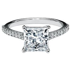 a princess cut diamond engagement ring with pave set diamonds on the shoulders and sides