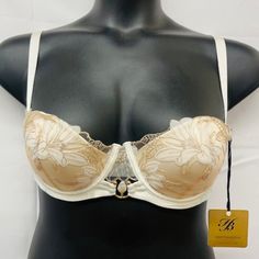 -Cut Down Push Up Cup -Lilium Embroidery Of Swiss-Design -Thermo-Cut Flowers On Crystal Tulle -Removeable Shoulder Straps -Gold-Plated Hardware & Pearl Barbell Ring -Hook & Eye Fastening -Comes With Honey Birdette Hanger Cream Lace Bra With Lace Trim, Wedding Lace Bra In Beige, Cream Lace Underwire Bra, Cream Underwire Bra With Delicate Lace, Fitted Beige Bra With Lace Trim, Elegant Full Cup Cream Bra, Feminine Cream Lace Bra, Fitted Beige Lace Trim Bra, Elegant Cream Underwire Bra