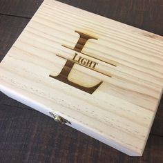 a wooden box with the word light engraved on it