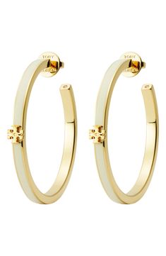 A signature double-T ornament charms the curves of these enamel-trimmed hoops that add a subtle splash of elegance to your lobes. Post back 1 5/8" hoop diameter 18k-gold plate/enamel/crystal Imported Designer Enamel Jewelry With Polished Finish, Yellow Gold Enamel Hoop Earrings, Luxury White Enamel Earrings, Elegant Enamel Hoop Earrings, Elegant Enamel Hoop Jewelry, Silver Enamel Hoop Jewelry, Silver Hoop Enamel Jewelry, Classic White Hoop Earrings With Polished Finish, White Luxury Hoop Earrings