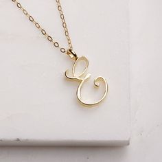 E Initial Necklace - Cursive "E" initial gold pendant - Personalized initial gold pendant for women / Gift for her / for mom / for wife / Cursive "E" initial. Perfect every day necklace. Lovely gift for your self, sister, bridesmaids, new mom. Pendant: Base metal is brass and 14K gold plated. Chain is 18 inches, 14k gold filled. Note: model shots might show a different initial, only to illustrate overall look and length of the chain. This listing is for the "E" initial. Cursive E, Birthday Gifts Ideas For Women, E Initial Necklace, Friend Letters, Every Day Necklace, E Initial, Alphabet E, Souvenir Jewelry, Sideways Initial Necklace