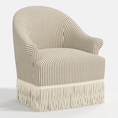 a striped chair with fringe trim around the armrests and back, on a white background