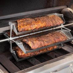 two racks with ribs cooking on an outdoor grill