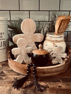 a wooden tray with some cookies and other items