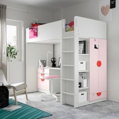 a loft bed with pink and white furniture in a child's playroom or bedroom