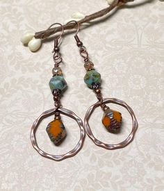 Casual boho earrings with a rustic fall vibe.  These were created using orange Czech Picasso glass bi-cone beads, turquoise Czech Picasso English cut beads, small Czech beads in champagne, antique copper accents, and antique copper hammered hoops. These earrings are great for fall, but the boho vibes are also great any time of year! Total length of earrings, including the ear wire, is approximately 2-1/2".  The hoops measure slightly less than 1" x 1". For matching bracelet, click on the link below: https://www.etsy.com/listing/1804981873/rustic-boho-bracelet-great-for-fall?click_key=abd72bb77c96c982d63f30c522f196ec4baca950%3A1804981873&click_sum=dfe57588&ref=shop_home_active_1&frs=1&sts=1 Thank you for shopping with The Lucie Collection! Bohemian Nickel-free Rust Earrings, Bohemian Rust-colored Nickel-free Earrings, Bohemian Rust Earrings With Ear Wire, Rust Bohemian Earrings For Pierced Ears, Rustic Drop Earrings With Ear Wire, Bohemian Copper Hoop Earrings, Bohemian Teardrop Copper Hoop Earrings, Rustic Dangle Earrings For Festivals, Bohemian Brown Wire Wrapped Hoop Earrings