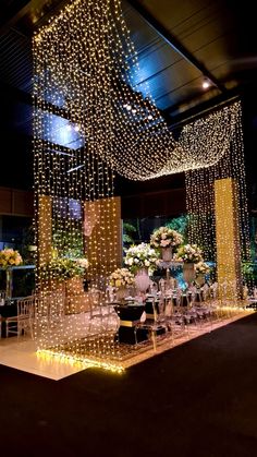 an indoor wedding setup with white flowers and chandeliers