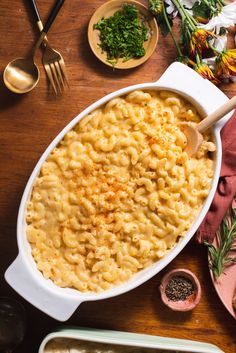 macaroni and cheese in a white casserole dish on a wooden table