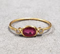 1. Diamond & Ruby 18k Gold Ring 2. Made to Order 3. Gemstone - Ruby, Diamond  4. Jewelry Type - Gold Ring 5. Total Weight - 0.990 Gram Approx. 6. Diamond Weight - 0.05 Carats  7. Ruby Weight - 0.75 Carats 8. Gold Weight - 0.830 Grams Approx.  9. Ruby Size - 4 x 5 MM 10. Gold Purity - 18k 11. Band Size - 1 MM 12. Handmade Items 13. AAA Quality Ring 14. Stackable Ring 15. 1 Quantity Available 16. Ready to Dispatch in 1 - 2 days.  Pictures are taken under natural and day light. Bezel Set Ring Handmade, Raw Ruby Ring, Bezel Set Ring, 18k Gold Ring, Red Band, Red Ruby, Ruby Ring, Birthstone Ring, Stackable Rings