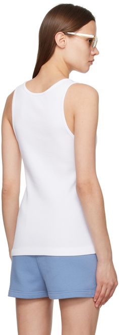 Rib knit cotton tank top. · Scoop neck · Embroidered logo patch at chest Supplier color: White White Crew Neck Tank Top With Ribbed Neckline, White Tank Top With Ribbed Crew Neck, White Sleeveless Tank Top With Ribbed Neckline, Summer Cotton Tank Top With Ribbed Neckline, Cotton Tank Top With Ribbed Neckline For Summer, White Tank Top With Ribbed Neckline, Fitted Cotton Tank Top With Ribbed Neckline, Baby Fox, Cotton Tank Top