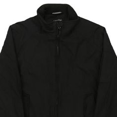 Description:Vintage black Calvin Klein jacket, fits medium.GENDER: mens CONDITION: very good.STYLE: jacketERA: 1990sCOLOUR: blackFABRIC: cotton Black Cotton Windbreaker In Techwear Style, Black Cotton Techwear Windbreaker, Black Cotton Outerwear For Cold Weather, Black Cotton Techwear Track Jacket, Black Cotton Windbreaker For Winter, Black Cotton Track Jacket With Pockets, Classic Black Windbreaker For Streetwear, Classic Black Cotton Outerwear, Casual Black Cotton Track Jacket