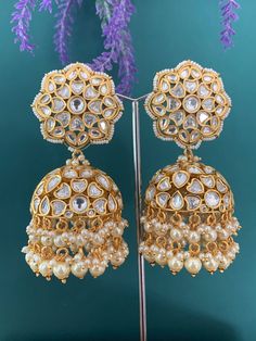 Top quality tyanni / AC kundan jhumki. Medium to over size.  3 inch long and 2 inch wide. Push back, light weight and gold plated. Super suitable for ppl with metal allergies. Pearl drops and lining . Gold Bollywood Jhumkas For Reception, Festive Heavy Jhumkas For Reception, Gold Heavy Jhumkas For Reception, White Cutdana Jhumkas For Reception, Heavy Danglers For Reception And Festivals, Polki Necklace, Back Light, Kundan Earrings, Over Size