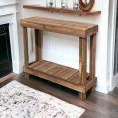 a wooden table sitting on top of a hard wood floor next to a fire place