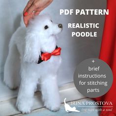 a white poodle wearing a red bow tie is being petted by someone's hand