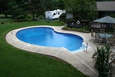 an above ground pool surrounded by lawn furniture