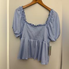 Beautiful Derek Heart Smocked Ruffle Top Short Sleeve. Light Blue. Size 2x. Nwt. Spring Puff Sleeve Top With Elastic Waistband, Chic Blue Smocked Top With Smocked Cuffs, Chic Blue Smocked Top With Smocked Back, Chic Blue Smocked Back Top, Chic Blue Smocked Top, Blue Stretch Smocked Top For Spring, Short Sleeve Smocked Back Top, Spring Smocked Back Top In Solid Color, Trendy Smocked Top With Ruffles For Day Out