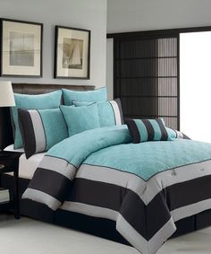 a bed in a room with blue and black comforters