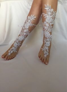 a woman's legs with white lace and flowers on them