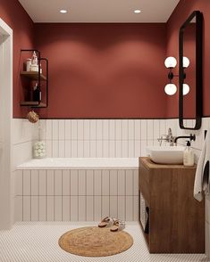 a bathroom with red walls and white tiles on the floor, along with a wooden cabinet