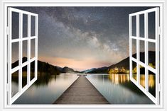 an open door leading to a lake with a view of the night sky and stars