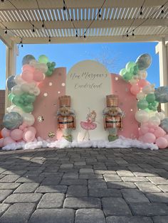 an outdoor stage set up for a ballerina themed birthday party with balloons and decorations