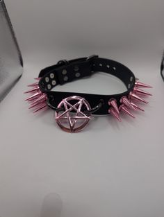 Handmade Choker made from 1 inch wide black Vegan/Faux Leather. Features a double row of one inch long spikes, and a pink  pentagram ring :) this will best fit necks 13-16 inches. Please check out more of my work on IG :) @ _SxbjectDelta_ Pink Pentagram, Pentagram Ring, Black Mountain Nc, Handmade Chokers, Scene Emo, Black Mountain, Black Vegan, Choker Necklaces, One Inch