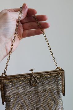 "This is such a special antique purse. It is intricately beaded with silver tone and gold tone beads. The beaded of the purse has a natural patina that add to its charm. The metal hardware of the purse is in an antiqued gold tone and filigree design. The purse opens to reveal a peach tone lining. The lining is very old and shows its age. It is very delicate and could be easily replaced. The pocket of the purse is still intact as is its mirror. The purse is so special and with the lining needs to Vintage Rectangular Bags With Gold Embroidery, Antique Beaded Rectangular Evening Bag, Handmade Victorian Gold Bags, Antique Beaded Evening Bag, Antique Beaded Evening Bag For Formal Events, Luxury Gold Beaded Evening Bag, Vintage Silver Embellished Evening Bag, Antique Gold Evening Bag, Antique Gold Rectangular Bag