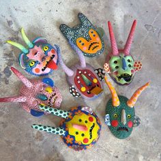 several colorfully painted animal figurines sitting on the ground