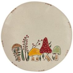 a plate with mushrooms and plants painted on the front, sitting on a white surface