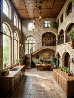 a large stone building with lots of windows and plants on the counter top in front of it