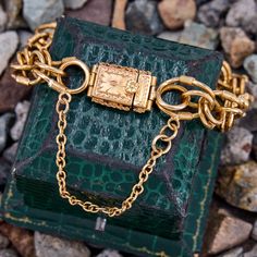 This unique fancy link bracelet is made from 19k yellow gold and its stamps indicate it was crafted in Porto Portugal between 1938 and 1984. It is finished with a beautifully engraved box clasp and safety chain. Antique Yellow Gold Link Bracelet, Antique Formal Bracelets With Box Clasp, Antique Gold Bracelets With Box Clasp, Rectangular Gold Bracelet With 17 Jewels, Antique Yellow Gold Jewelry With Box Clasp, Antique Gold Rectangular Bracelet, Vintage Yellow Gold Rectangular Link Jewelry, Vintage Yellow Gold Jewelry With Rectangular Links, Timeless Gold Engraved Bracelets