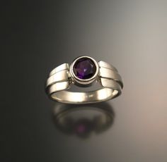 Amethyst natural 6mm round stone is deepest color. Well cut and eye-clean natural stone from Nigeria weighs a little over 1ct. Bezel set with forged tapered multidimensional band. Specify your size at check-out. Modern Rings With Tension Setting, Modern Round Birthstone Ring With Tension Setting, Modern Amethyst Ring With Bezel Setting, Modern Amethyst Ring With Polished Finish, Modern Amethyst Birthstone Ring, Elegant Round Amethyst Ring With Tension Setting, Round Cut Polished Amethyst Ring For Anniversary, Round Cut Amethyst Ring With Polished Finish For Anniversary, Modern Amethyst Rings In Round Shape