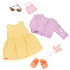 the doll is wearing a yellow dress and shoes with sunglasses on her head, holding a pink purse